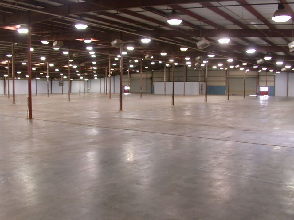 The empty main expo hall at Huntington Bank Expo with polished concrete floors and high ceilings